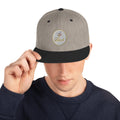 Man wearing a black and tan 46Blast snapback hat